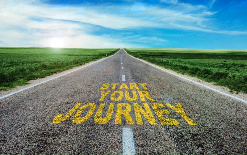 Start Your Journey written on asphalt road.