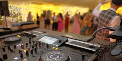 DJ setup at a lively evening event.