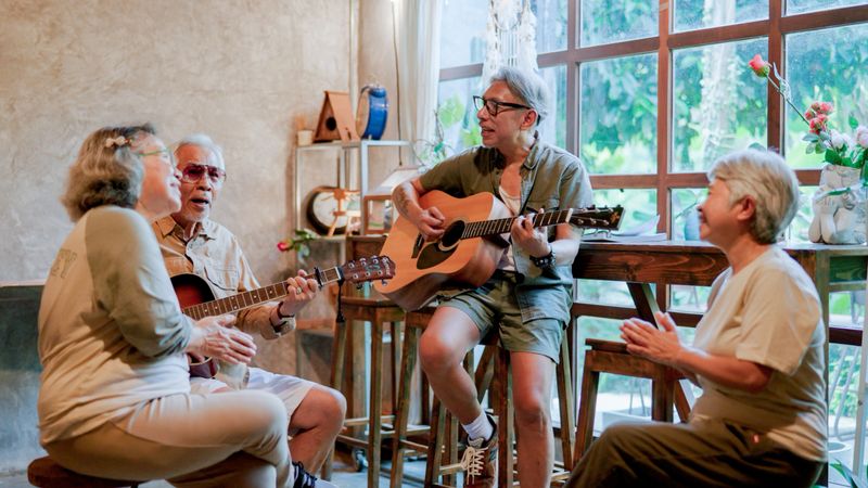 A group of old Asian friends starting a musical session together at home on weekend.
