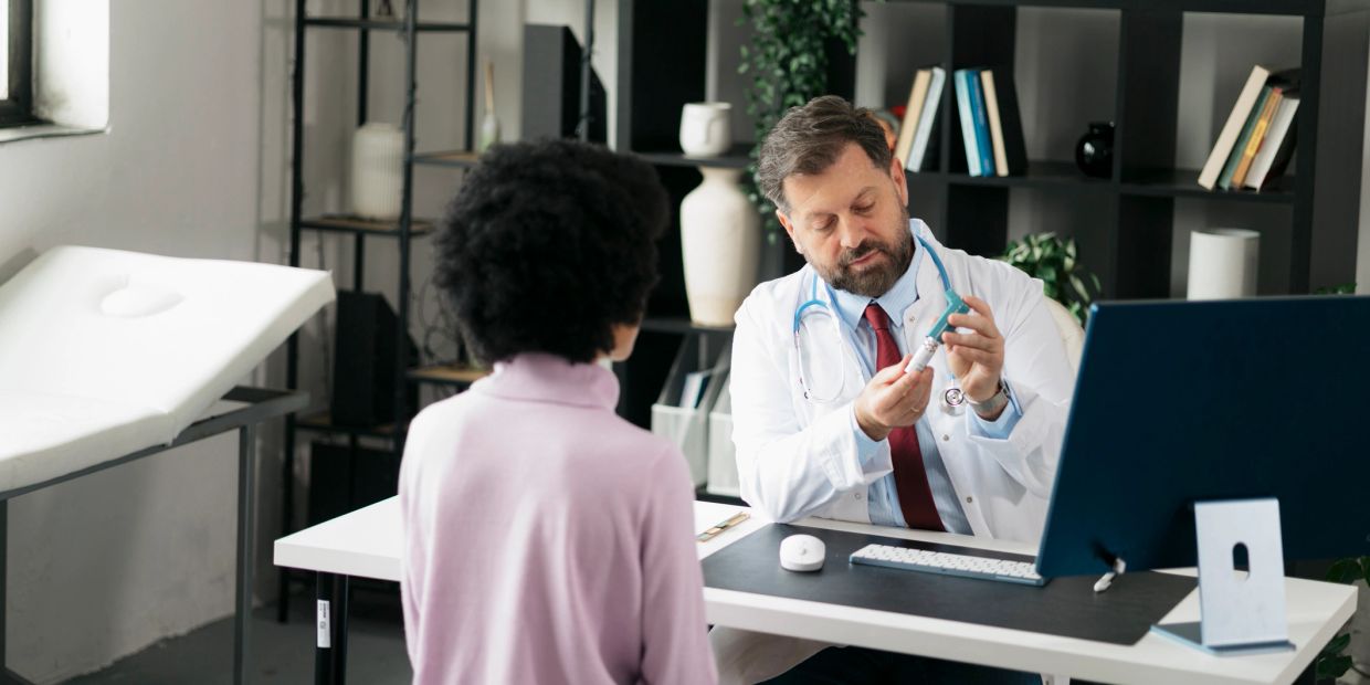 Doctor explaining a vaccine to a patient.