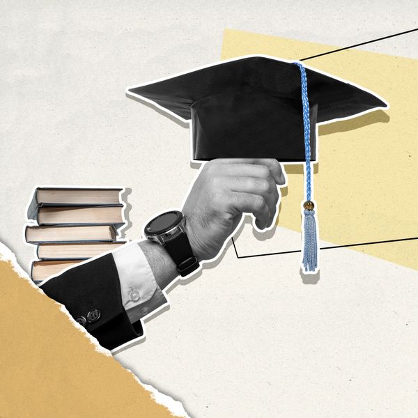 Hand holding graduation cap with stacked books in background, symbolizing education.