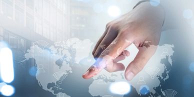 Hand interacting with digital world map and Wi-Fi icons representing global connectivity.