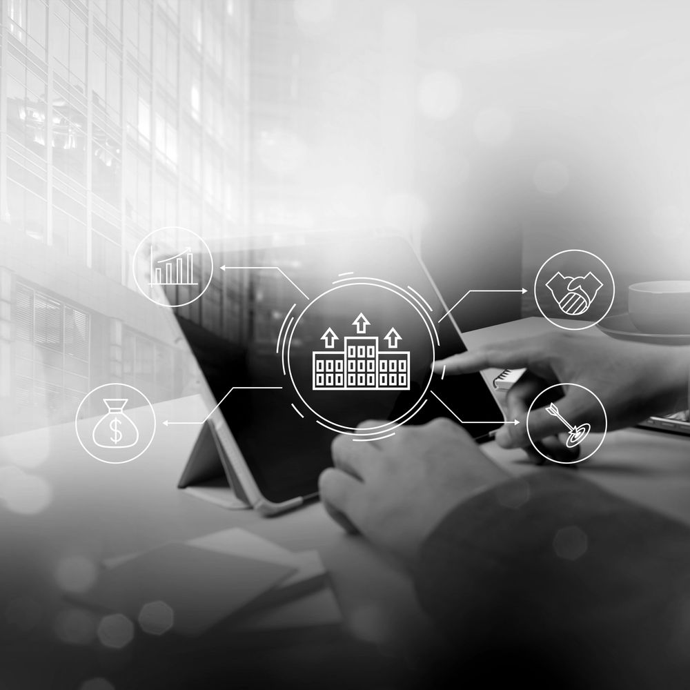 Person using tablet with business growth icons overlay.