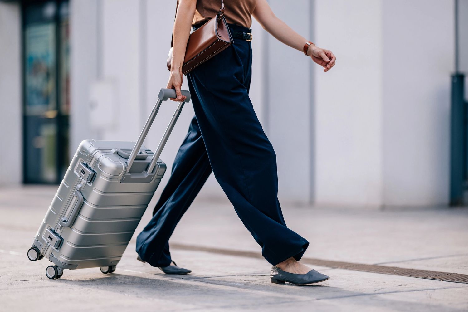 A traveler walking with rolling luggage through a modern airport, ready to explore Japan's culture, famous attractions, and unforgettable travel experiences.