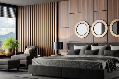 Modern bedroom with wooden panel walls and circular mirrors.