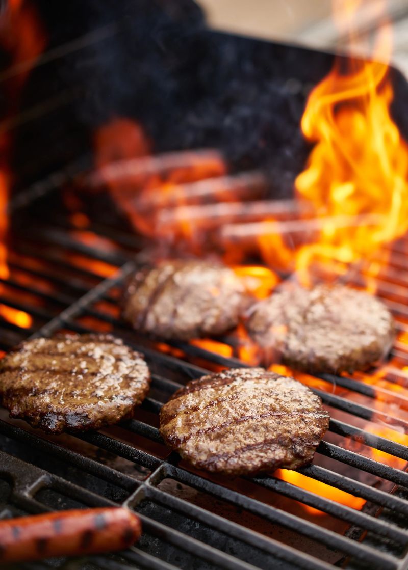 hamburgers and hot dogs being grilled