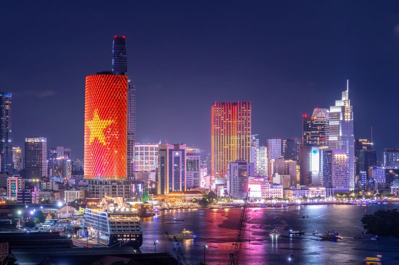Aerial view of Ho Chi Minh City skyline and skyscrapers on Saigon river, center of heart business at downtown. Night view. Financial and business concept