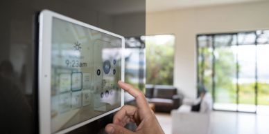 Hand interacting with a smart home control panel.