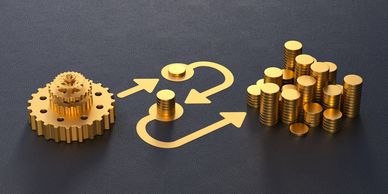 Golden gears, arrows, and coin stacks on a dark surface symbolize financial process and growth.