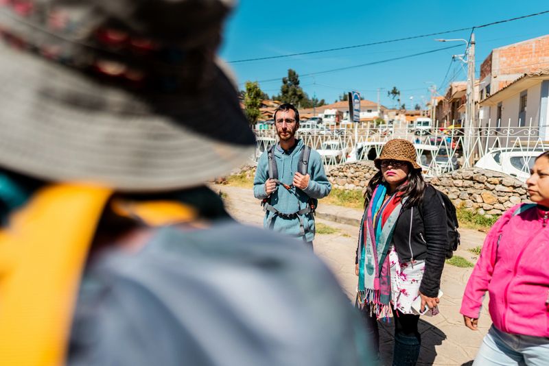 Tourists listening tour guide on Chinchero district