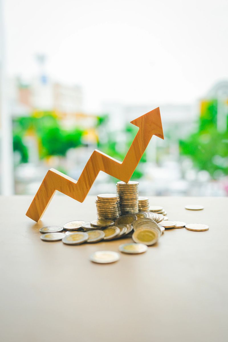 Up Arrow symbol with coins stack. Concepts of the banking system, rising interest rates, inflation, deflation, and savings.