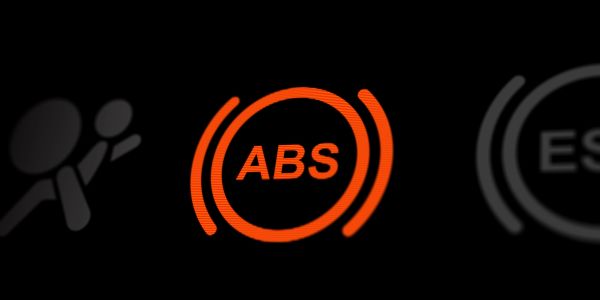 Orange ABS warning light on a car dashboard.