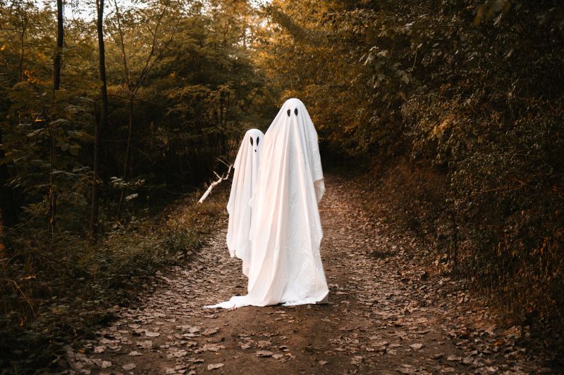 Two ghosts on the road dressed for Halloween. Halloween costume