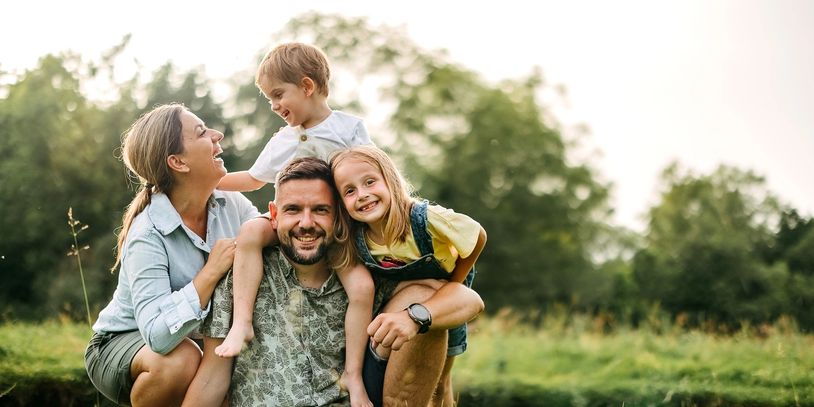 Happy family enjoying a sunny day outdoors in nature.