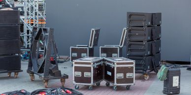 Audio equipment and flight cases on stage floor.