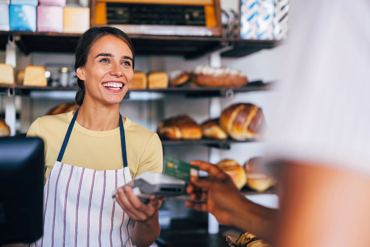 Smiling bakery worker accepting card payment from a customer. business property insurance
commercial property coverage
Florida insurance solutions