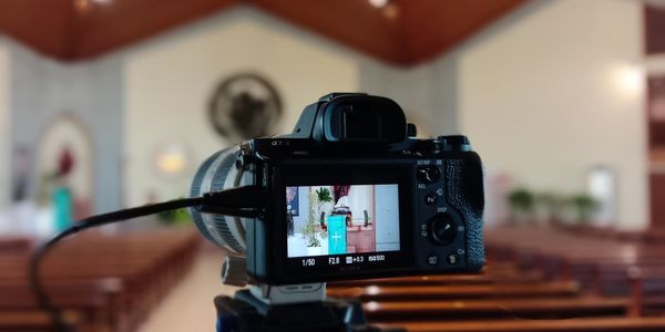 Camera on tripod capturing the interior of a church altar.