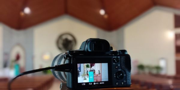Camera focusing on a lectern inside a church interior.