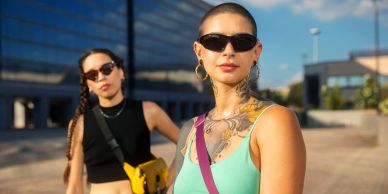 Two stylish women outdoors wearing sunglasses.