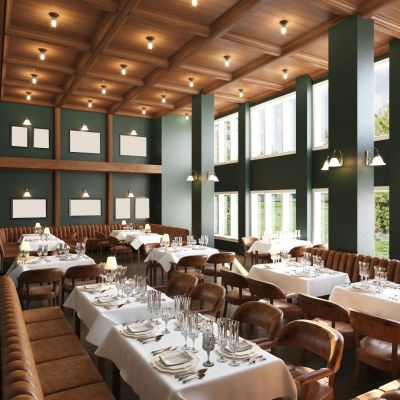 Elegant restaurant interior with wooden ceiling and neatly set tables.