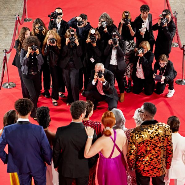 Photographers capturing celebrities on the red carpet.