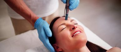 Close-up of lip injection procedure on a woman's face.