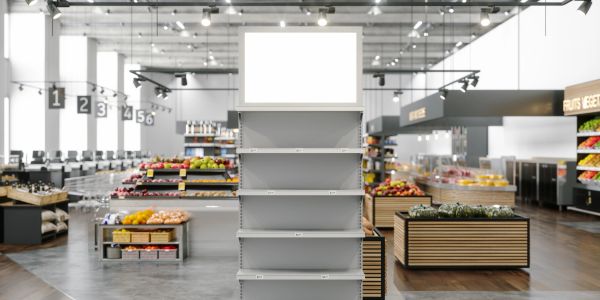 Empty white shelves in a modern grocery store aisle.