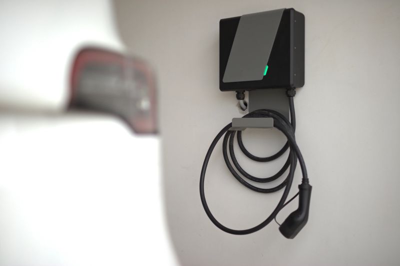 Electric car and electric car charger installed in the private garage at home.