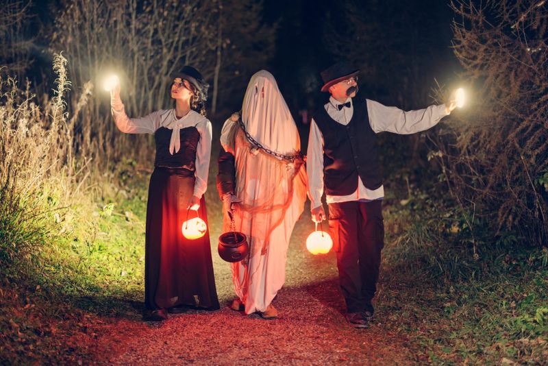 Dressed up teenagers are strolling in the dark forest on Halloween evening.Shot with Canon R5