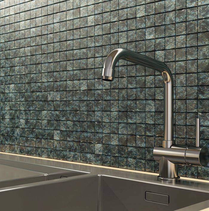 Modern kitchen sink with a sleek stainless steel faucet and dark tiled backsplash.