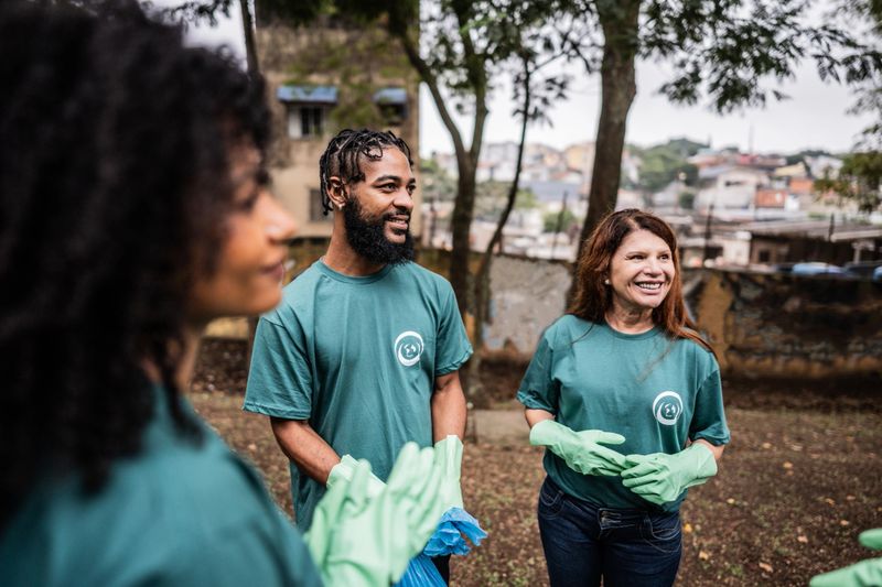 Group of volunteers talking at public park