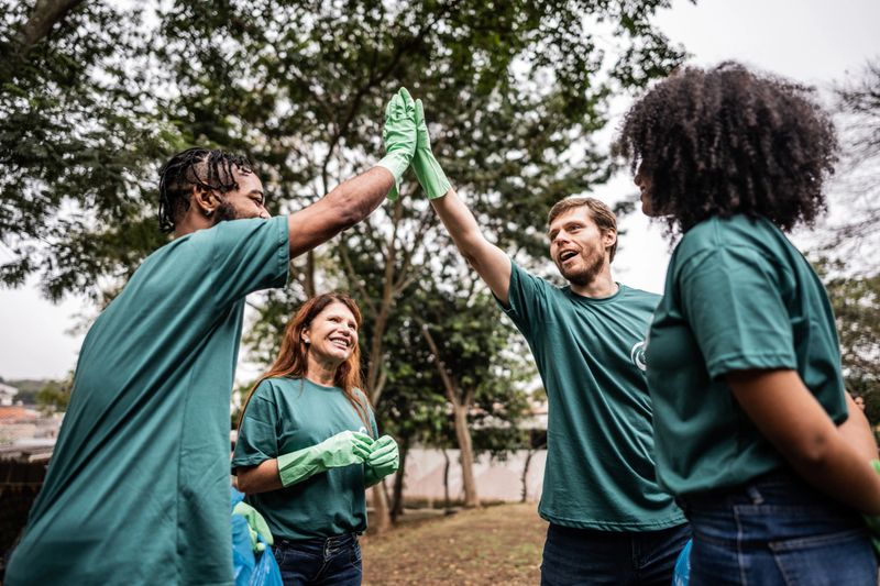 Volunteers friends greeting at public park