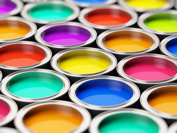 Open cans filled with vibrant, colorful paint in various shades.