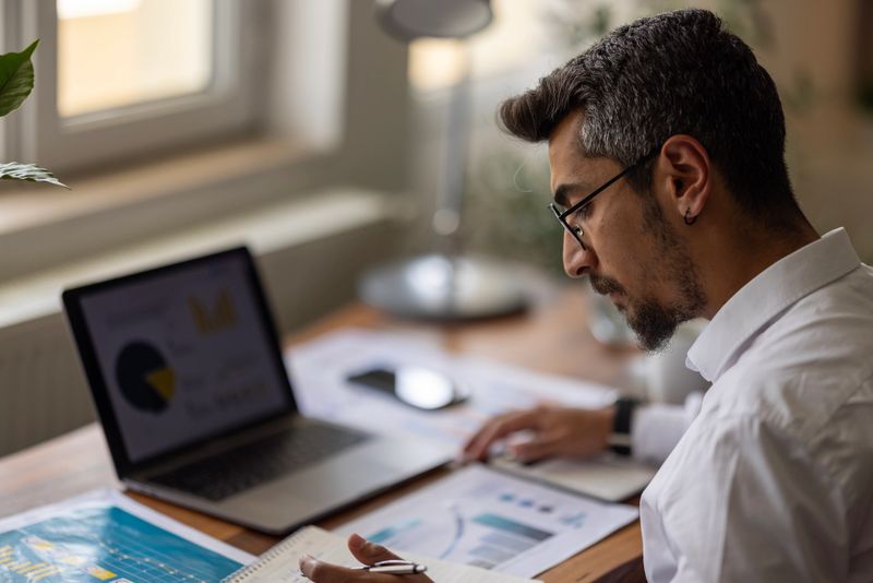 Businessman working on Financial Report of corporate operations, balance