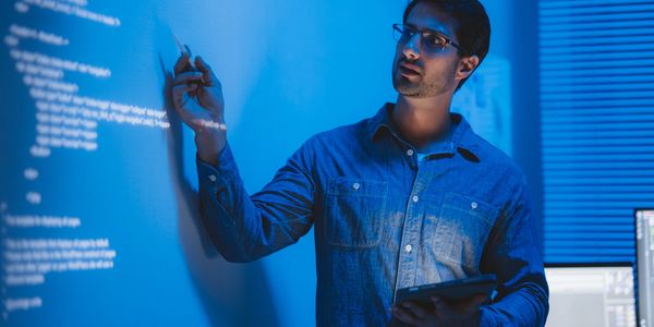 man presenting on whiteboard rent_a_ciso