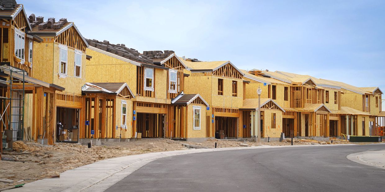 Row of new houses under construction in a residential development.