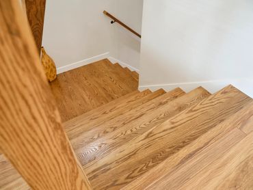 Wooden staircase with a minimalist design and a decorative vase.