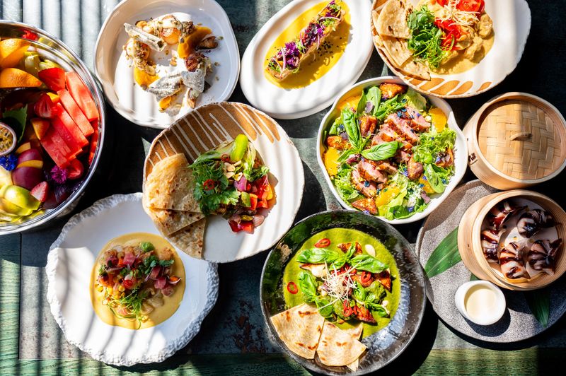 variety of colorful dishes arranged on a table, showcasing a diverse and appetizing meal. vibrant presentation highlights fresh ingredients and culinary creativity, perfect for food-related content.