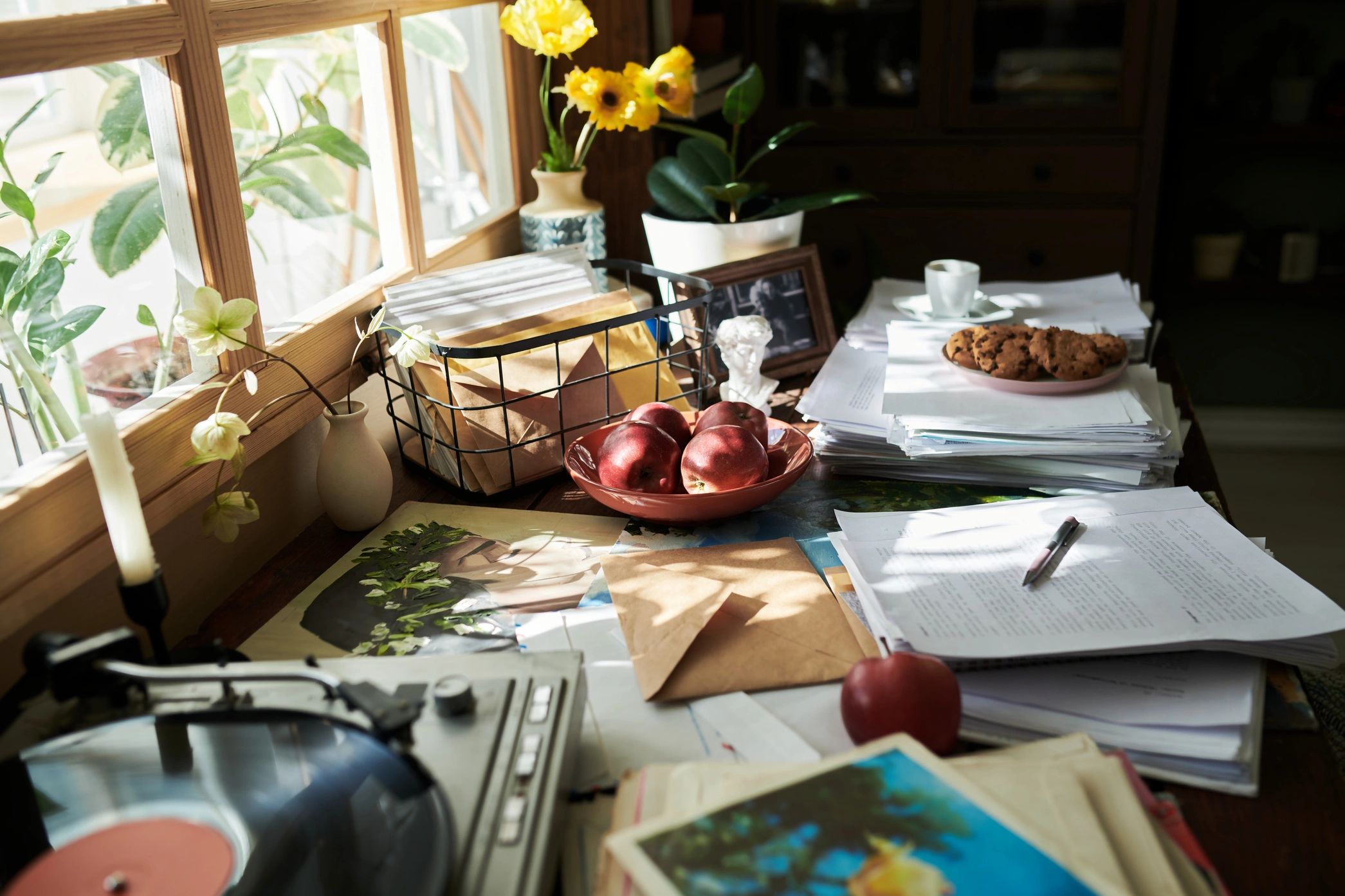Paper clutter on a dining table before organizing, highlighting decluttering and home organization s