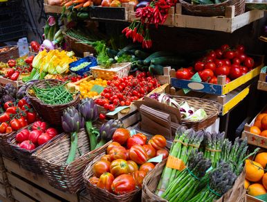Colorful fresh vegetables displayed at a market stall.