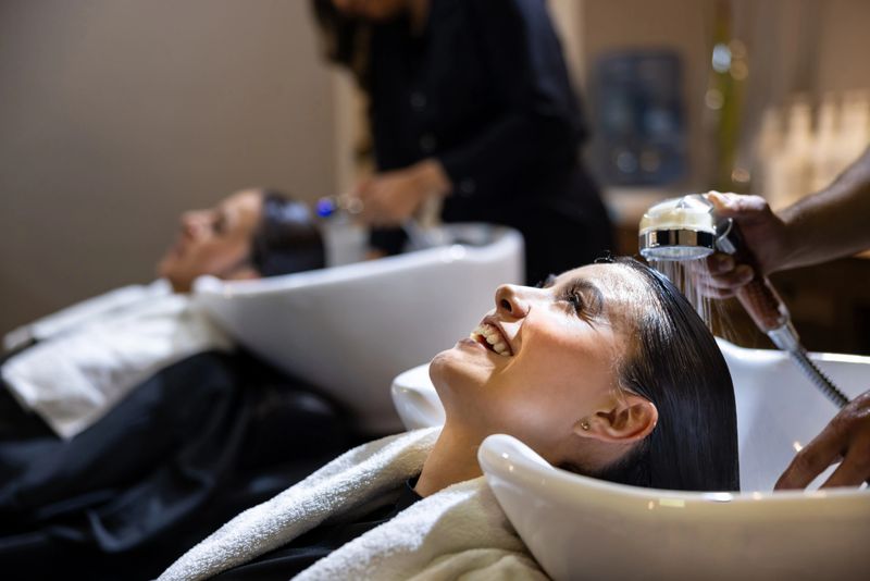 Latin American women getting their hair washed at the hairdressers - beauty concepts