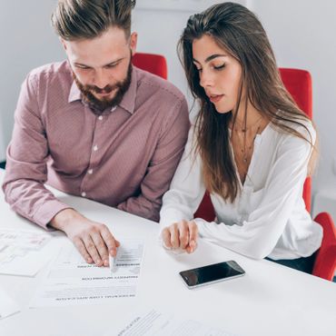 Couple reviewing and signing a residential loan application together.