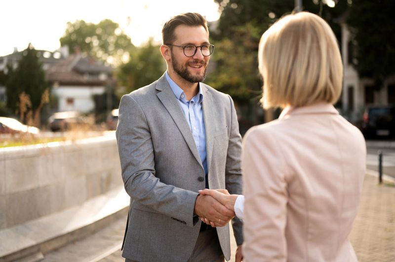 Businesswoman and businessman shaking their hands, meet and greet and making contract, agreement