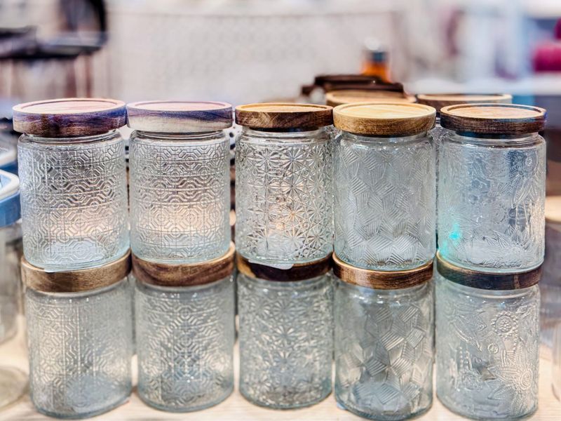 A collection of vintage glass jars stacked in a neat arrangement.