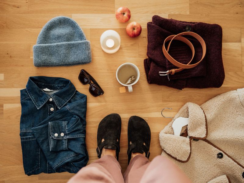 Autumn fashion flat lay with knits and shoes and jacketPhoto taken from above overhead
