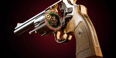 Close-up of a revolver with a roulette wheel inside the cylinder.