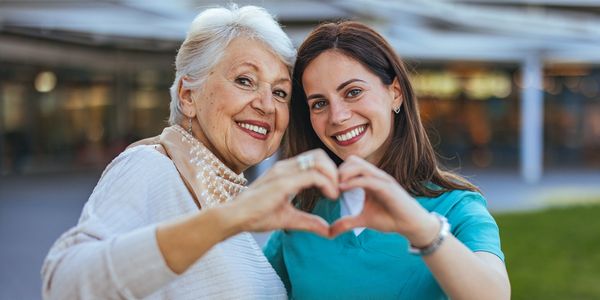 Mobile specialty health care near me. An elderly woman and a young woman making a heart shape with t