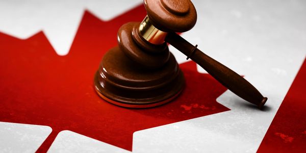 A judge's gavel on a Canadian flag symbolizing Canadian law and justice.