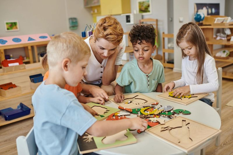 A dedicated teacher collaborates with diverse children, exploring didactic materials at a vibrant Montessori school.