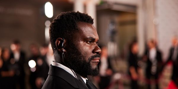 Man in a suit at a formal event, possibly security or an attendee.